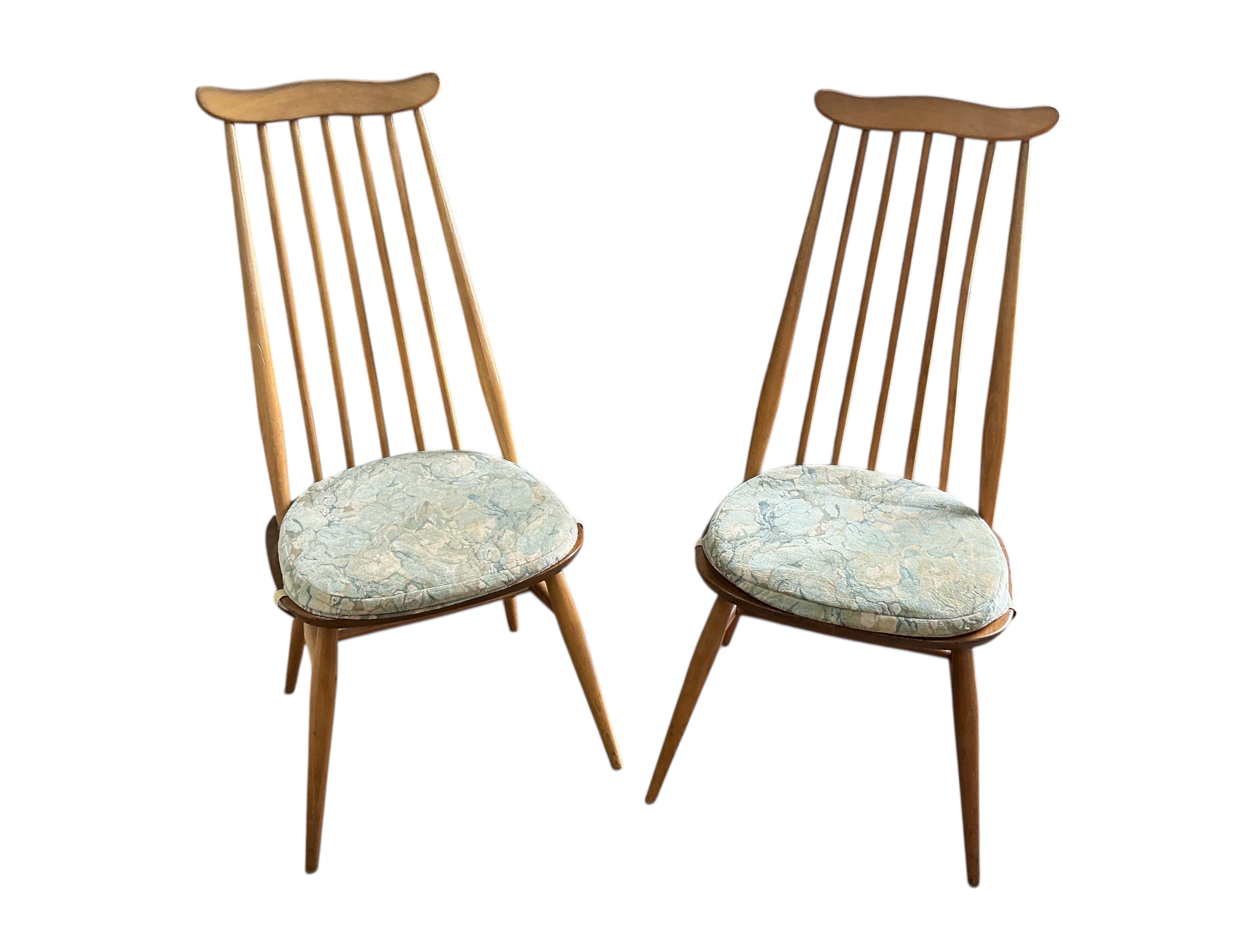 An Ercol elm and beech drop leaf dining table, width 112cm, depth 62cm, height 72cm and four Ercol elm and beech comb back dining chairs